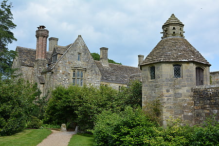 gray concrete structure surrounded by green leafed trees and plants thumbnail