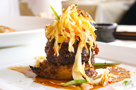 grilled meat with vegetable on top on white ceramic plate thumbnail