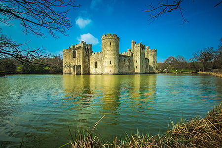 gray concrete castle surrounded by body of water thumbnail
