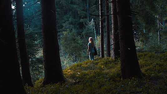 woman standing on green grass field during day time thumbnail