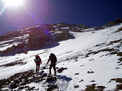 two hikers hiking on mountains covered by snow thumbnail