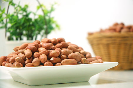 brown almond nuts on white ceramic plate thumbnail