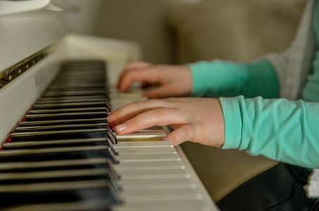 selective-focus photography of person playing piano thumbnail