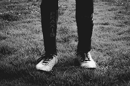 grayscale photography of person standing on grass thumbnail
