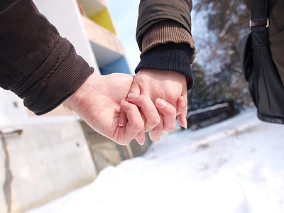 two person holding hands during daytime thumbnail