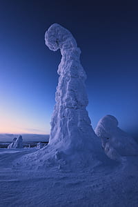 low angle photography of stone filled with snow thumbnail