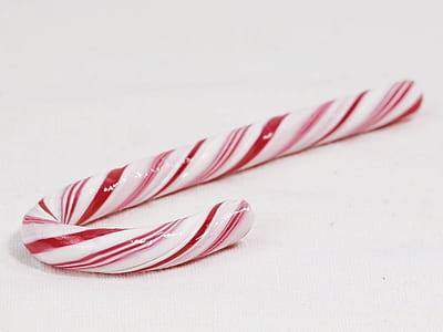 red and white candy cane on white surface thumbnail