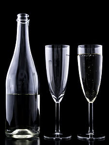 two clear drinking glasses beside clear glass bottle thumbnail