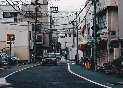 black car on street near buildings thumbnail
