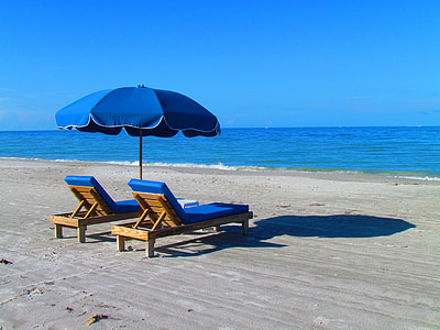 two lounger under umbrella in seashore thumbnail