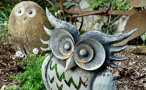 gray owl statue on green grass thumbnail