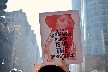 person holding woman's place is in the resistance print thumbnail