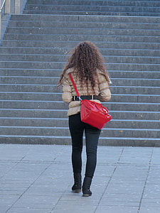 person walking near staircase carrying red patent leather sling bag thumbnail