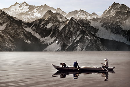 three person riding boat on body of water thumbnail