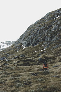 person walking on mountain during daytime thumbnail