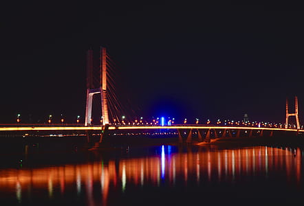 landscape photography of bridge at night time thumbnail