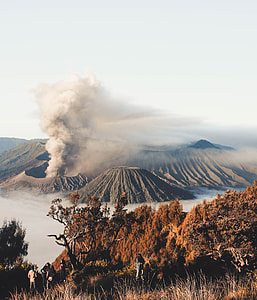 erupting volcano surrounded by clouds thumbnail