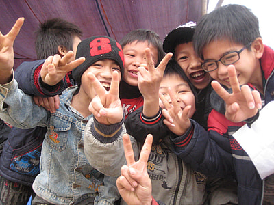 children standing near each other gesturing peace sign thumbnail
