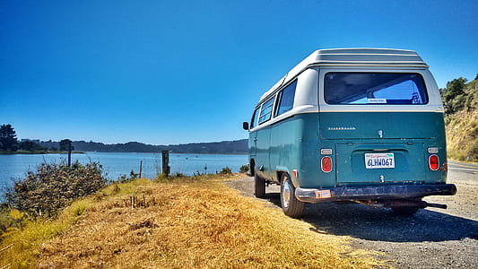 white and blue Volkswagen T2 near body of water thumbnail