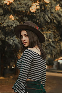 woman in black and white striped long-sleeved top looking back thumbnail