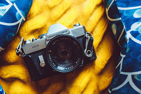black and gray SLR camera on yellow textile thumbnail