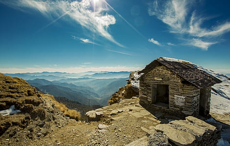 landscape photography of brick house on mountain thumbnail
