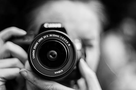 grayscale photo woman holding camera thumbnail
