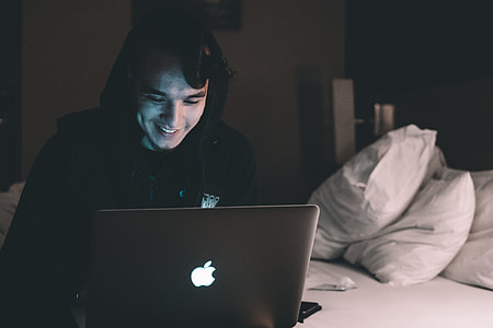 man infront of MacBook thumbnail