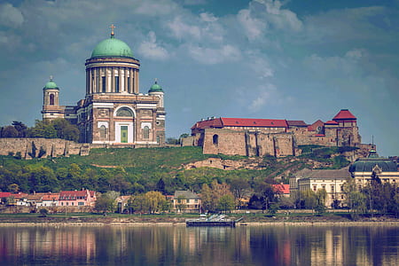Beige and White Dome Building Near Body of Water thumbnail
