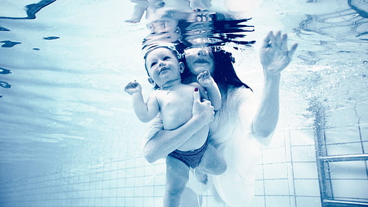 woman holding baby while underwater thumbnail