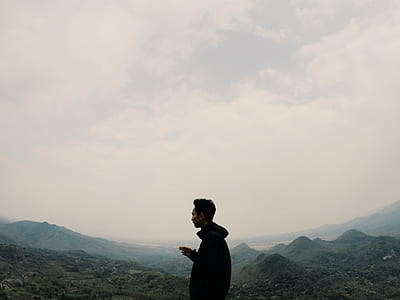 man standing near mountain thumbnail