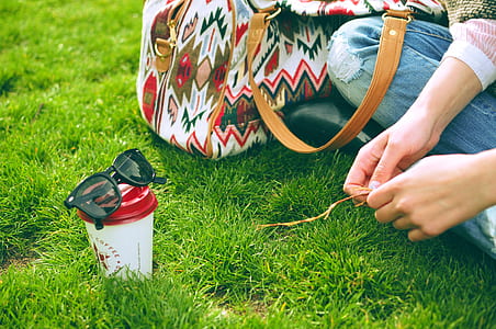 person sitting on green grass thumbnail