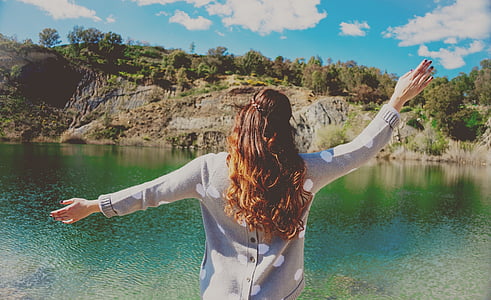 woman waving over the lake thumbnail