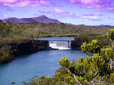 landscape photo of waterfalls near green trees thumbnail