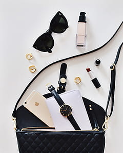 black sunglasses beside lipstick and bag thumbnail