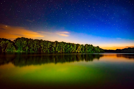 body of water near trees during daytime thumbnail