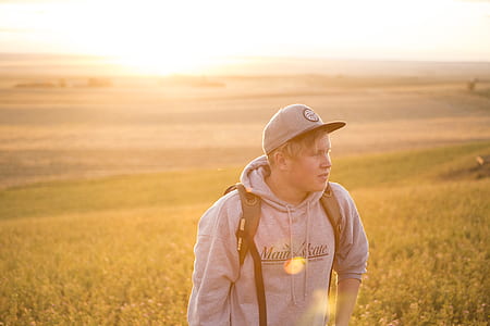 man standing on grass field thumbnail