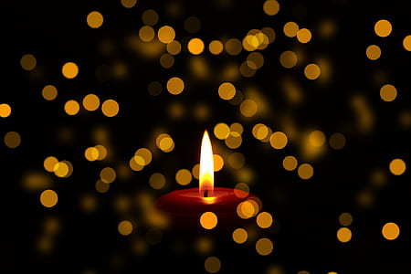 close up photo of lighted red candle bokeh photography thumbnail