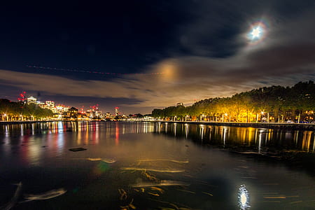 body of water with lighted bridge under black sky during nighttime thumbnail