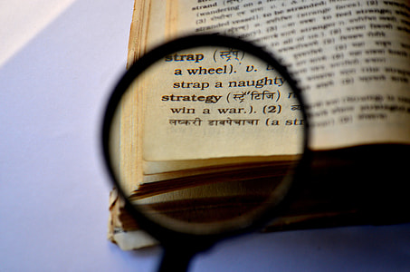 magnifying glass near book thumbnail