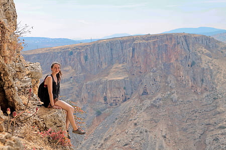 woman sitting on mountain cliff thumbnail