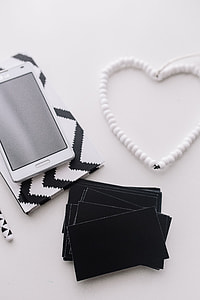 Black-and-white notebook and a white smartphone with various items thumbnail