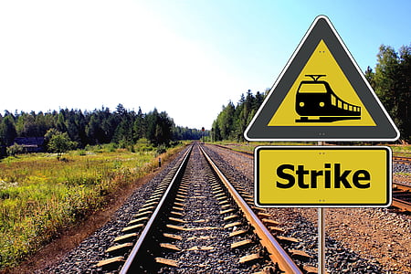 yellow-and-black train strike signage at daytime with no train thumbnail