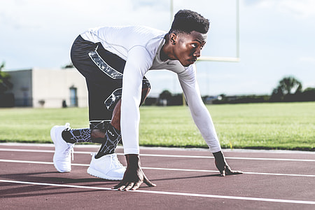 man standing on race track at daytime thumbnail