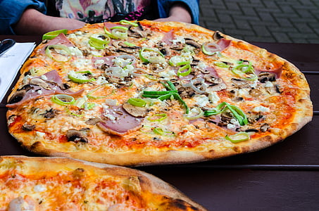 round pizza on table thumbnail