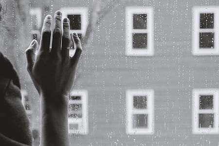 grayscale photo of person looking out the window thumbnail