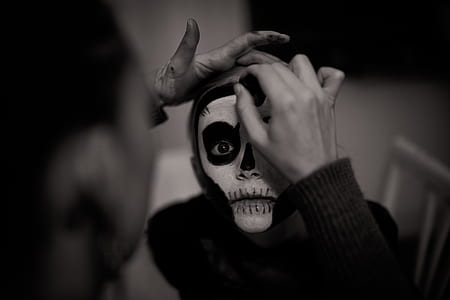 grayscale portrait photo of person with skull face paint thumbnail