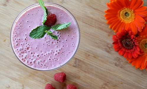 cup of strawberry shake near orange artificial flowers graphic wallpaper thumbnail
