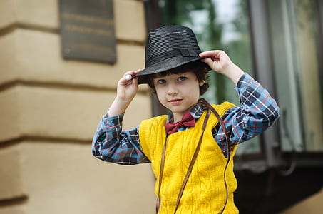 man wearing black hat standing near the building thumbnail
