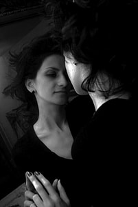 grayscale photo of woman facing mirror thumbnail